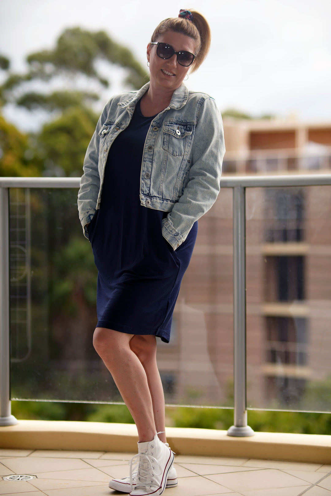 Model wearing Kip and Boo Designer Pyjamas with denim jacket sunglasses and sneakers