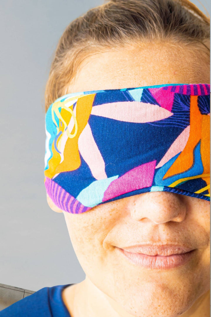 Closeup photo of model wearing bamboo sleeping eye mask in cancun print soft comfortable