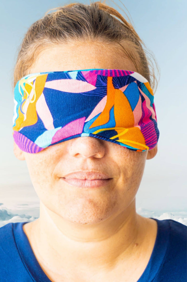 Model wearing cancun print soft bamboo eyemask for sleeping and navy pyjama top